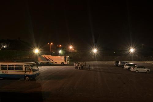 a parking lot at night with cars and lights at Ramoji Sahara Shared Accommodation in Pedda Ambarpet