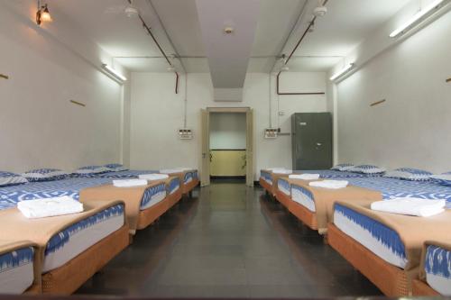 a room with a bunch of beds in it at Ramoji Sahara Shared Accommodation in Pedda Ambarpet