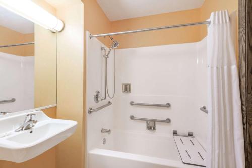 a bathroom with a sink and a shower at Days Inn & Suites by Wyndham Youngstown / Girard Ohio in Girard