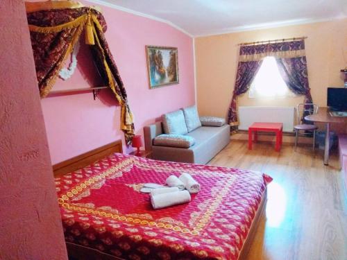 a bedroom with a bed with a teddy bear on it at Old Castle Hotel in Lviv