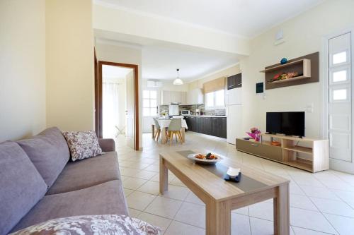 a living room with a couch and a table at Maria's Garden in Galatás