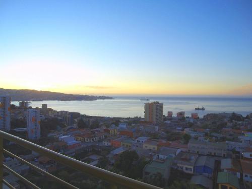 a view of a city at sunset from a balcony at Alluring View at Valparaiso departamento in Valparaíso