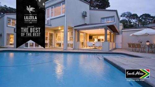 a large swimming pool in front of a house at Forest Manor Boutique Guesthouse in Durban
