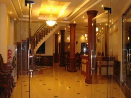 a hallway with a glass door in a building at Asia Hotel in Battambang