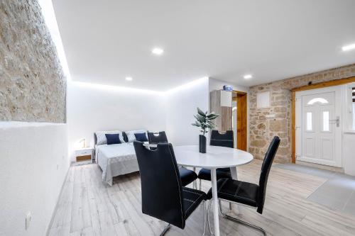 a bedroom with a bed and a table and chairs at Falcons Nest in Šibenik