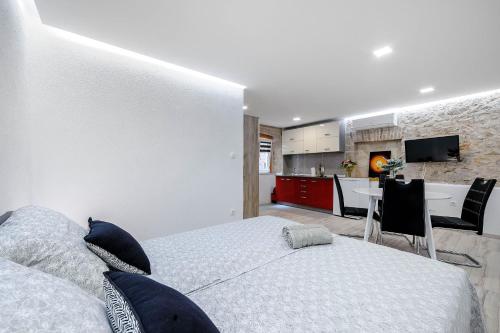 a bedroom with a king sized bed and a kitchen at Falcons Nest in Šibenik