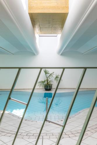 a view of a swimming pool from a window at Boutique-Hotel Ballguthof am Golfplatz in Lana