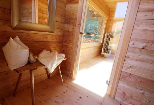 an inside view of a wooden cabin with a bench and a window at Residenz Erschbaum in Valdaora