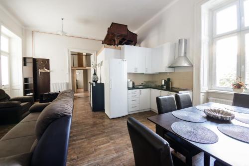 uma cozinha e uma sala de estar com mesa e cadeiras em Urban Rooms em Budapeste