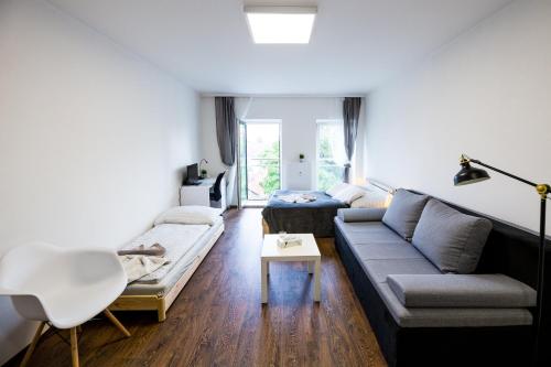 a living room with a couch and a table at Haas Apartments Downtown with Parking in Brno