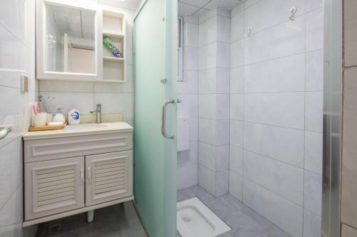 a bathroom with a shower and a sink and a toilet at Chengdu Chenghua·Giant Panda Breeding Base Locals Apartment 00149350 in Chengdu