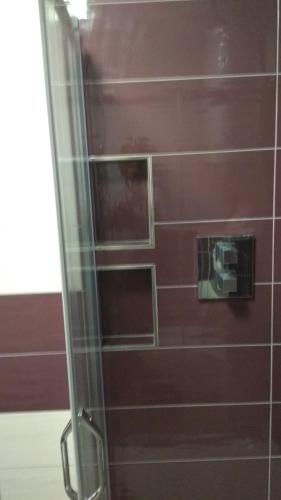 a bathroom with a shower with a red wall at Apt.Jana ,apt.Terezka in Stožec