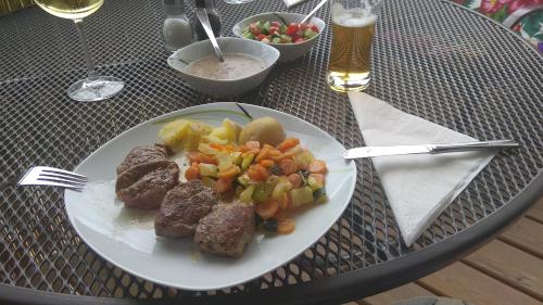 a plate of food with meat and vegetables on a table at Apt.Jana ,apt.Terezka in Stožec