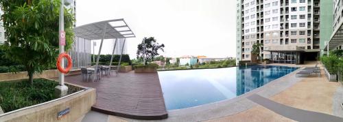 a swimming pool in the middle of a building at Lumpini Ville Wong Amat Beach in North Pattaya