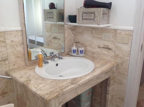 un bancone del bagno con lavandino e specchio di casa La sorgente di Carlo Magno a Otranto