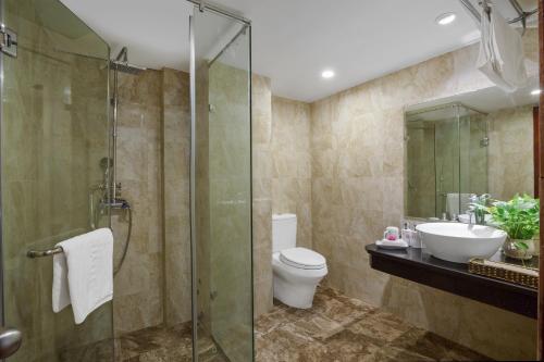 a bathroom with a toilet and a sink and a shower at Splendid Star Grand Hotel and Spa in Hanoi