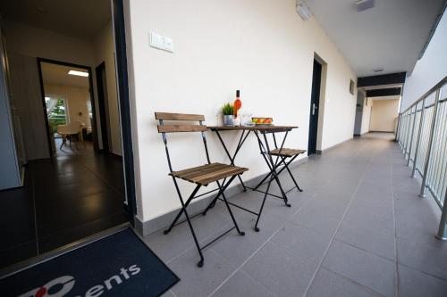 a hallway with a table and chairs in a building at Haas Apartments Downtown with Parking in Brno
