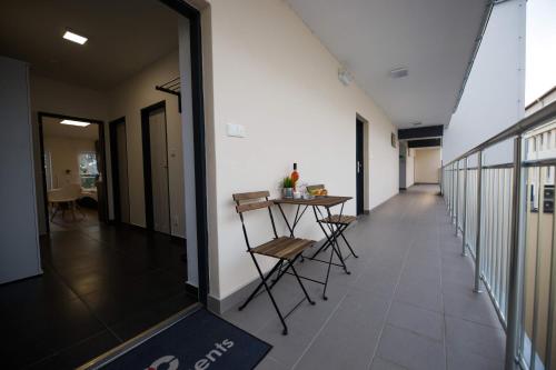 a hallway with a table and chairs in a building at Haas Apartments Downtown with Parking in Brno