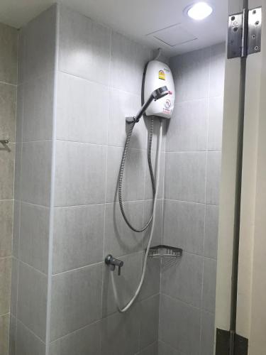a shower with a shower head on a wall at Lumpini Ville Wong Amat Beach in North Pattaya