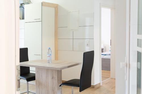 a dining room with a table and two chairs at Holidayapartment Rüsselsheim in Rüsselsheim