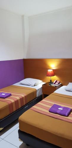 Säng eller sängar i ett rum på Hotel Dequr Jakarta Kota