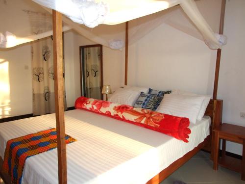 two bunk beds in a room with a mirror at Voyage Village in Mikumi