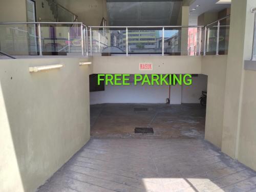 a free parking sign on a wall in a building at Classy Studio Apartment (KBCP) in Kota Bharu
