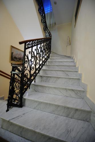 a staircase with a wrought iron railing and concrete steps at Hotel Royal Craiova in Craiova