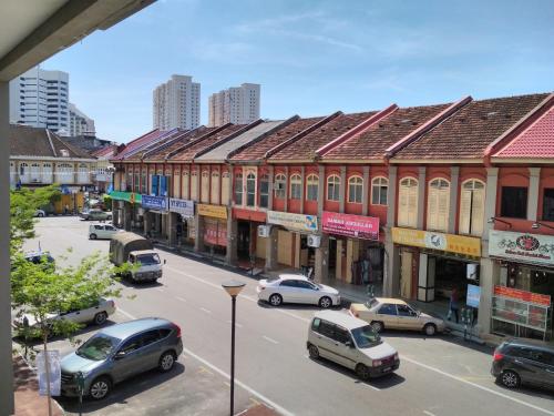 a city street with cars parked in front of buildings at Classy Studio Apartment (KBCP) in Kota Bharu