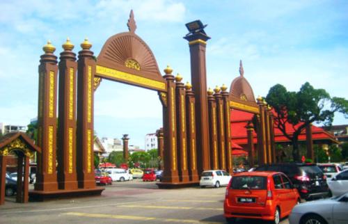 a red car parked in front of a building at Classy Studio Apartment (KBCP) in Kota Bharu
