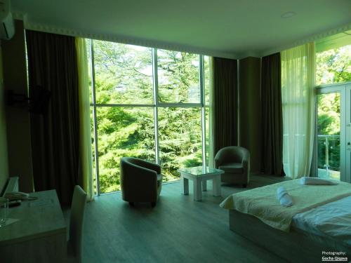 a bedroom with a bed and a large window at Resort Martvili in Martvili