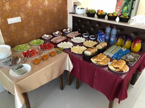 a table with a buffet of food on it at Hotel Living in Šuto Orizari