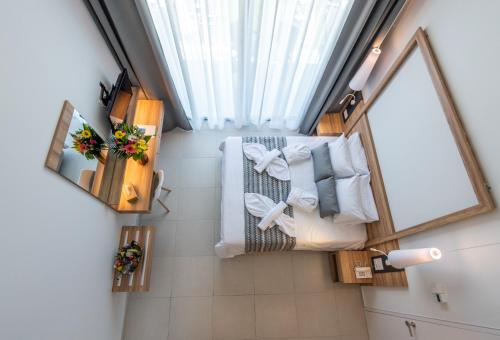 an overhead view of a bathroom with a bed and towels at Kiani Beach Resort Family All Inclusive in Kalyves