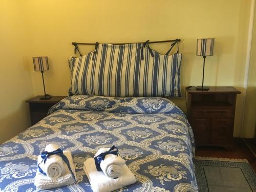 a bedroom with a bed with two towels on it at Finestra su Genova - free parking in Genoa