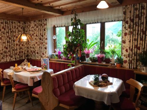 a restaurant with two tables and a pink couch at Haus Katharina in Wagrain