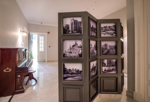 a group of pictures on a wall in a room at 1920s Boutique Hotel and Restaurants in Cairo