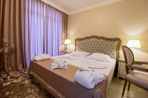 a hotel room with a bed with towels on it at Therma Palace - All inclusive & Private Beach & Free Parking in Kranevo