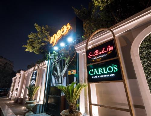 a sign for a caros restaurant on a street at night at 1920s Boutique Hotel and Restaurants in Cairo