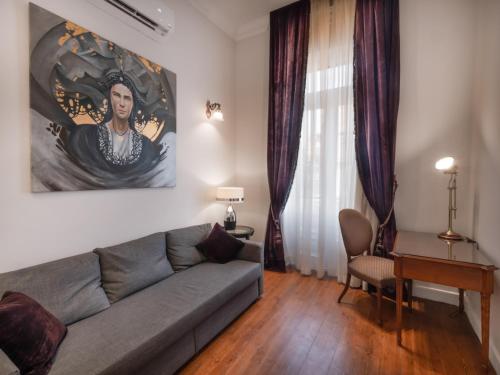 a living room with a couch and a table at 1920s Boutique Hotel and Restaurants in Cairo