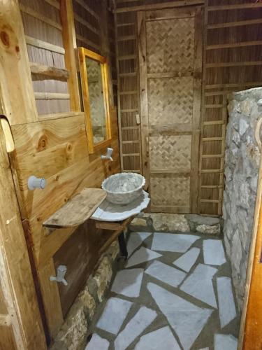 a bathroom with a sink and a stone floor at Tinaoog Beach Resort in Romblon