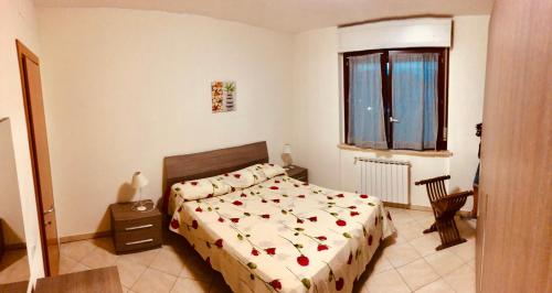 a bedroom with a bed and a window at Casa MALÙ 2 in Latina