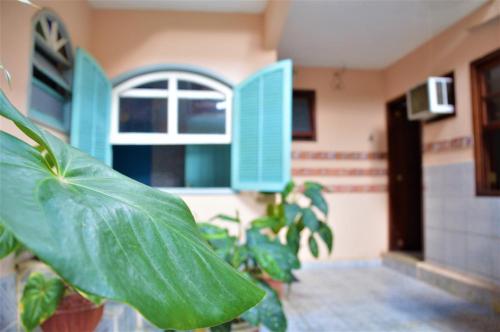 a room with green plants and a window at Pousada do Imperador in Paraty