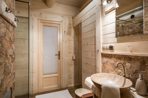 a bathroom with a sink and a walk in shower at Chata Przy Dolinie z sauną in Kościelisko