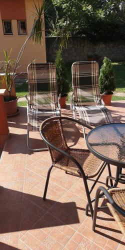 a group of chairs and a table and a table and chairs at Strigonia Apartman in Esztergom