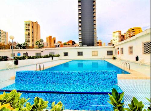 a swimming pool on top of a building with tall buildings at Ducado of the Sea in Benidorm