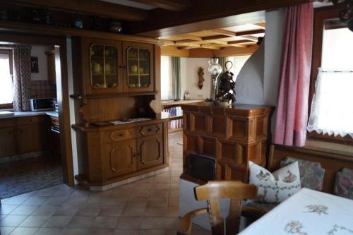a kitchen with wooden cabinets and a table in it at FEWO Außerlechner in Innsbruck