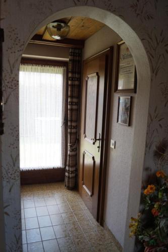 an archway leading to a hallway with a door and a window at FEWO Außerlechner in Innsbruck