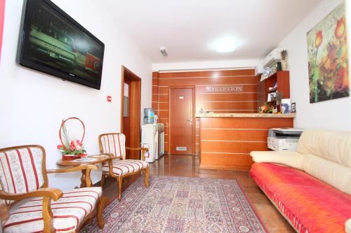 sala de estar con sofá y mesa en Guesthouse Villa Inn, en Subotica