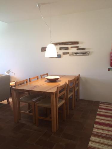 a dining room with a wooden table and chairs at Convento das Bernardas AZ in Tavira