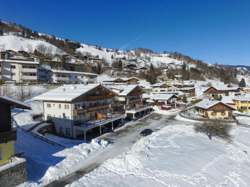 a small town in the snow with buildings at All Seasons Lodge by All in One Apartments in Kaprun